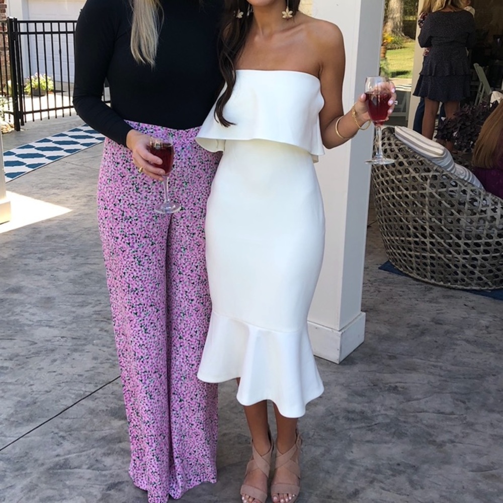 Likely white strapless dress with ruffle